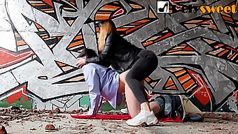 A Young Girl And A Masked Wife Engage In Outdoor Sex In A Graffiti-Covered Factory, Overlooking Passing Trains