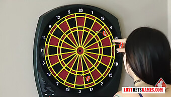 Attractive Women Engage In A Stripping Game Using Darts, With The Losing Participant Facing Consequences